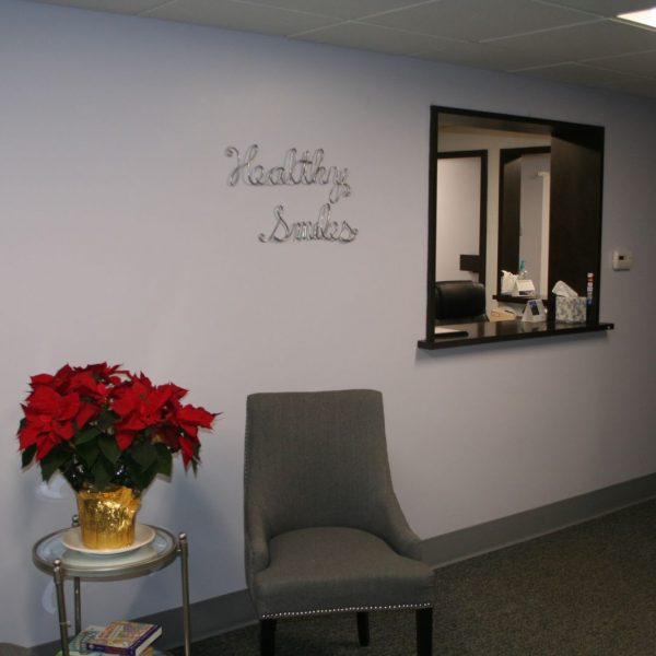 a picture of our front office greeting area with chairs and a poinsettia plant