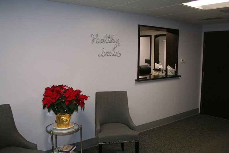 a picture of our front office greeting area with chairs and a poinsettia plant