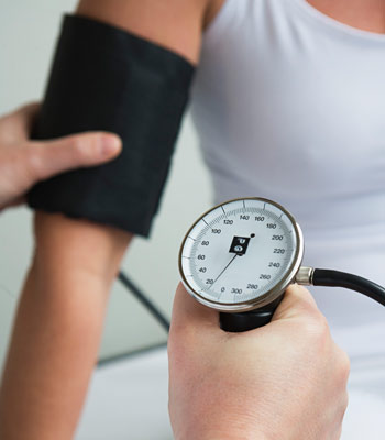 Man checking a woman's blood pressure from her arm